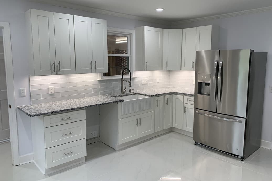 Completed Allison Builders compact kitchen with white cabinetry