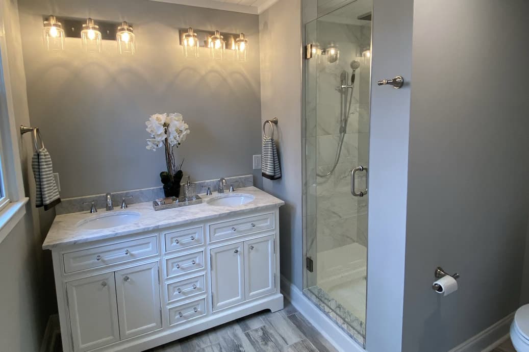 Completed Allison Builders bathroom with double vanity and glass shower