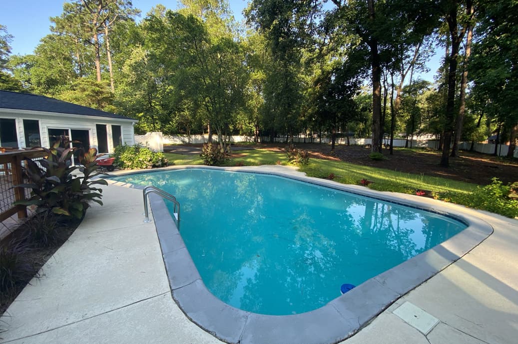 Backyard pool and landscaped garden completed by Allison Builders
